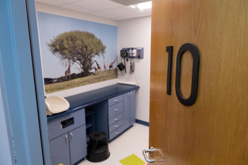 an open door to an exam room with a large number 10